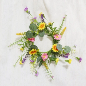 Detailed close-up of handmade artificial flower wreath with yellow daisies and lavender