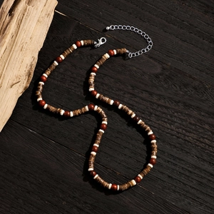 Macro shot of bohemian wood bead necklace with silver lobster clasp and extension chain