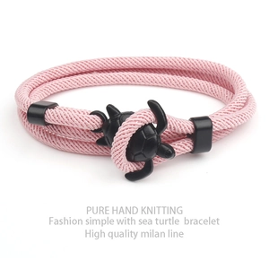 Pink hand-woven milan line bracelet with a black sea turtle charm and double wrap detail