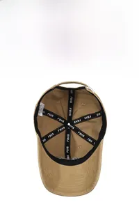 Detail view of khaki cotton baseball cap interior showing seams and washing label