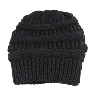 Close-up of the thick knit texture and warm black yarn detail of this winter beanie