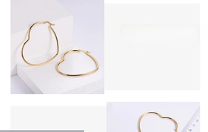 Polished gold heart hoop earrings with measurement scale showing size details