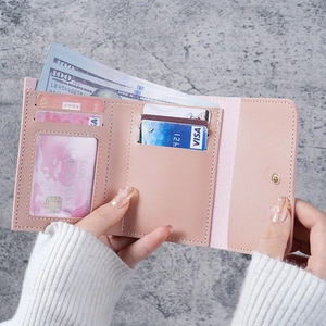 Slim tri-fold pink leather wallet for women with card slots and transparent ID window