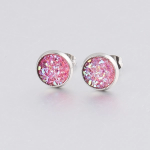 Macro view of 8mm pink glitter stud earrings with silver stainless steel backing