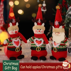 Three Christmas burlap gift bags featuring Santa, snowman, and reindeer doll designs