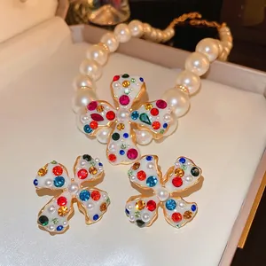 Exquisite pearl necklace and floral clover earrings set with multicolored crystals