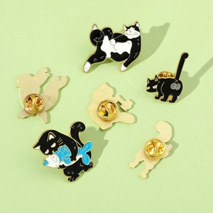 Detailed set of six black and white enamel cat pins in various playful poses and motifs