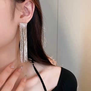 Elegant model shot of silver tassel earrings with sparkling crystals and long fringe design
