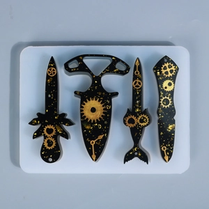 Steampunk style black resin sword and knife pendants with gold gear clockwork inserts