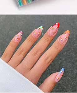 Close-up of rainbow heart pattern and gradient French tips on oval press-on nails