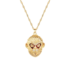 Luxurious gold monkey pendant necklace with sparkling diamonds and red crystal eyes