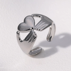 Minimalist silver stainless steel open heart ring with hands design in polished finish
