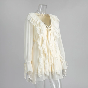 Close-up of chiffon dress featuring ruffled V-neckline and tiered ruffle layers