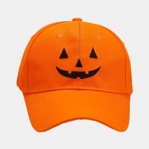 Close-up of Jack-o'-lantern embroidery and cotton texture on orange Halloween baseball cap