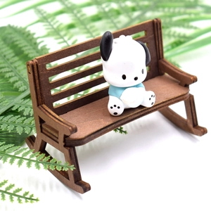 Macro shot of a cartoon dog figurine sitting on a miniature vintage wooden bench model