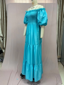 Detail of light blue off-shoulder smocked dress with tiered skirt and puff sleeves