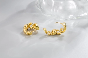 Detail of twisted rope gold hoop earrings showing the secure latch closure mechanism