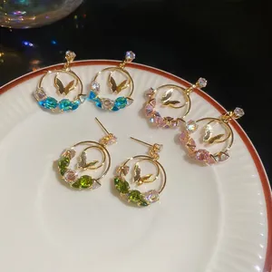 Three pairs of elegant geometric hoop earrings with butterfly charms and colorful zircons