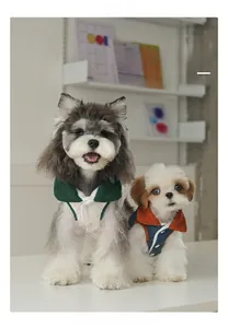 Detail view of contrast color quilted dog coat with corduroy collar and button snap closure