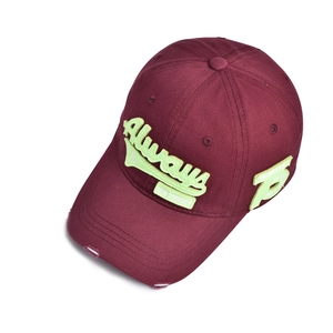 Detail of distressed baseball cap featuring neon green Always embroidery and vintage wash