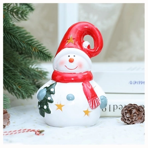 Detail of white hollow snowman figurine with red hat and scarf for Christmas decor