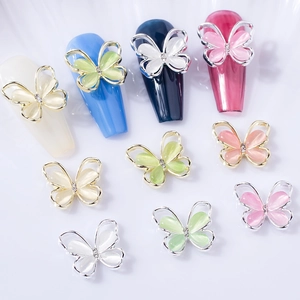 3D cat eye butterfly nail art charms with crystal accents in gold and silver metal frames