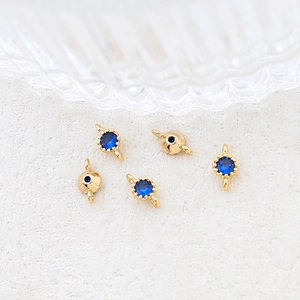 Macro shot of gold-plated connectors with blue zircon gemstones for DIY jewelry