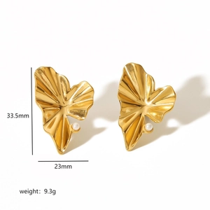 Detailed view of gold leaf earrings with small pearls and dimensions 33.5mm by 23mm