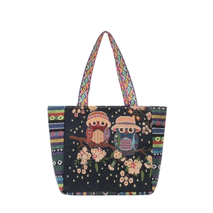 Ethnic canvas tote bag with colorful owl embroidery and floral patterns on black background