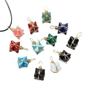 Natural crystal merkaba star pendants with gold wire wrapping on white background