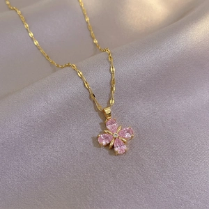 Elegant gold titanium steel necklace featuring a pink four-leaf clover pendant with zircon