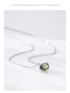 Detail shot of s925 sterling silver necklace with olive green oval gemstone pendant