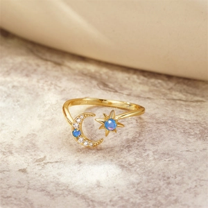 Macro view of S925 sterling silver gold-plated ring with blue opal star and moon design