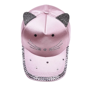 Detail of pink satin cap with crystal cat ears and sparkling rhinestone whiskers