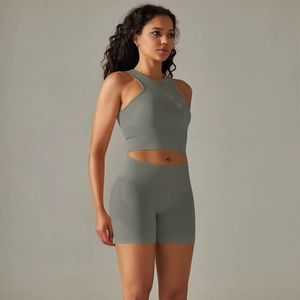 Detail of grey-green seamless ribbed knit yoga crop top and high-waisted fitness shorts