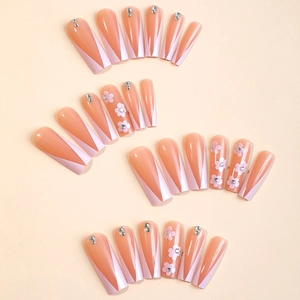 Long coffin press-on nails with nude pink French tips and 3D floral rhinestone accents