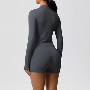 Back view of dark gray yoga set showing form-fitting long sleeve jacket and shorts