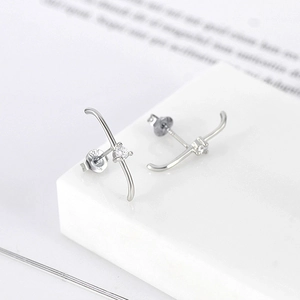 Macro shot of S925 sterling silver cross stud earring with a 925 authenticity stamp