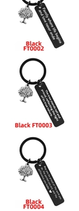 Close-up of tree of life charm and black engraved inspirational stainless steel keychain