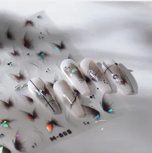 Vue macro de stickers ongles papillon laser avec nœuds 3D et strass irisés brillants
