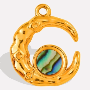 Macro detail of gold moon pendant featuring natural colorful abalone shell inlay