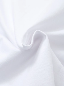 Close-up detail of soft white cotton knit fabric texture with natural folds for T-shirts