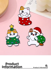 Detailed view of three cute Christmas cat enamel pins on a decorative wooden tray