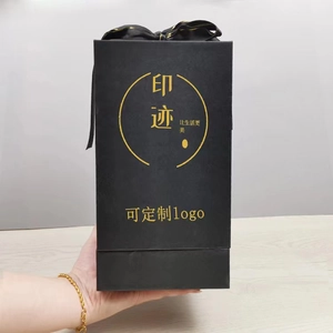 Elegant black gift box with gold logo and ribbon detail for preserved roses