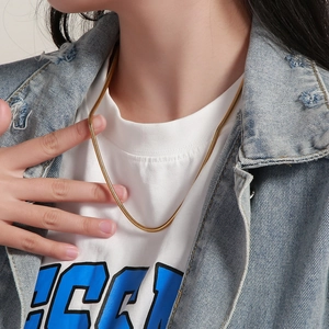 Elegant gold snake chain necklace for men and women, shown worn on a model's neck