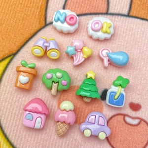 Close-up of colorful resin DIY charms including mini house tree and balloon shapes