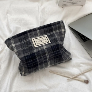 Close-up of vintage wool plaid cosmetic bag with a Pleasant Time woven label