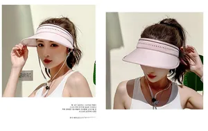 Detail of pink wide brim sun hat showing adjustable chin strap and lettered headband
