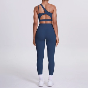 Detail of navy blue one-shoulder yoga set with cutout back design and high waist leggings