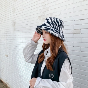 Detail shot of plush zebra print bucket hat featuring soft faux fur texture and warm fabric